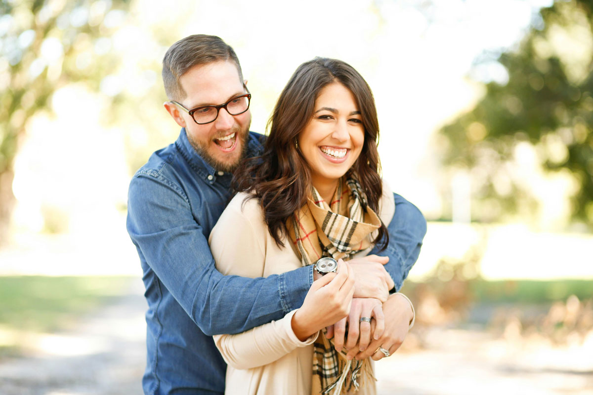 Young couple laughing outside together