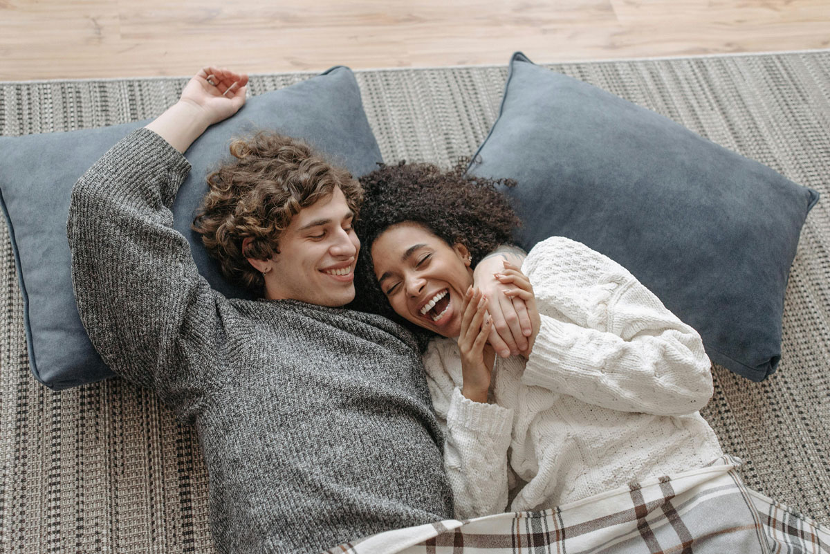young couple laying down together